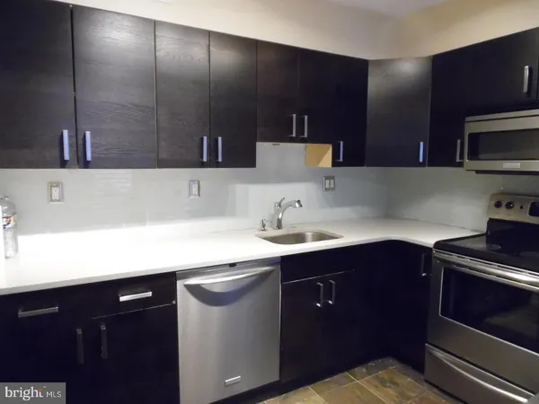 a kitchen with a sink and cabinets