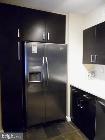 a kitchen with a refrigerator and sink