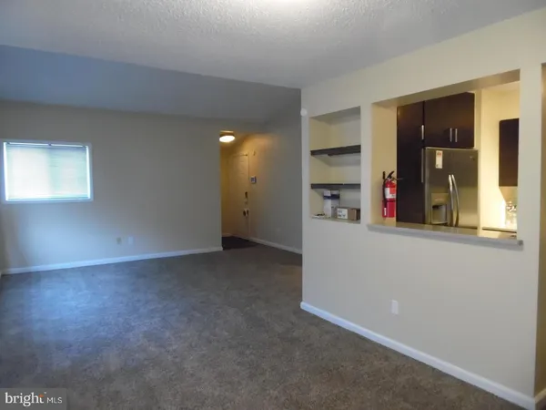 an empty room with closet and windows