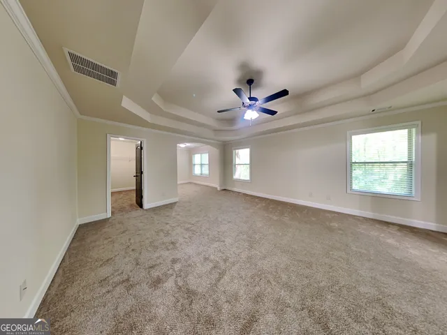 en view interior of a house with a ceiling fan and window