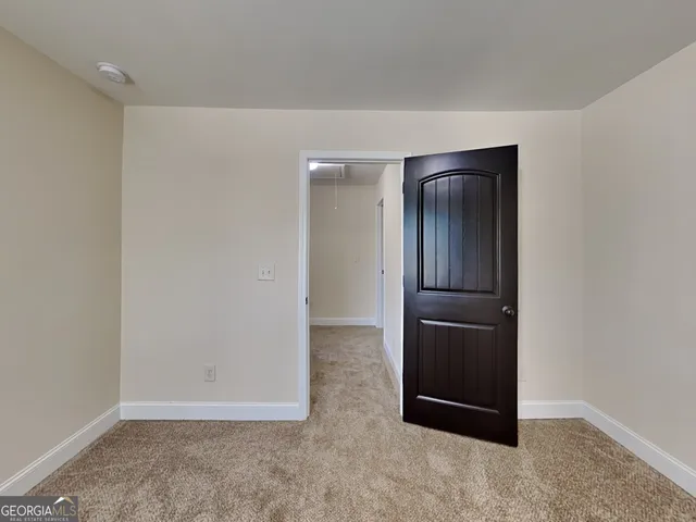 a view of a house with a small deck and wooden floor