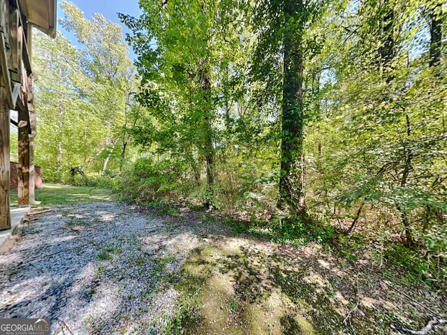 a view of brick house with a yard