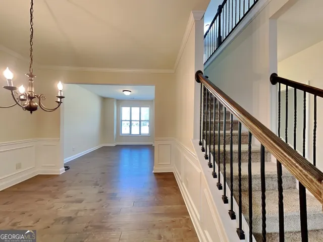 a view of a room with wooden floor and staircase