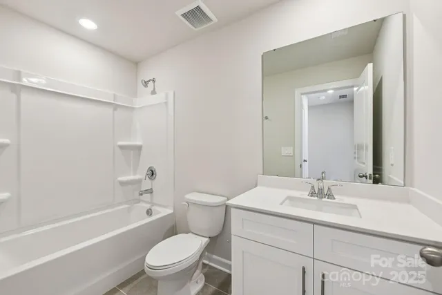 a bathroom with a sink a toilet and a large mirror