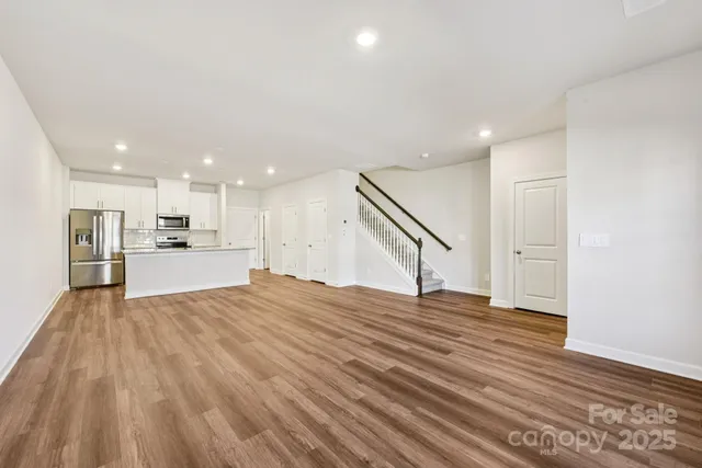 a view of a kitchen with wooden floor and a sink