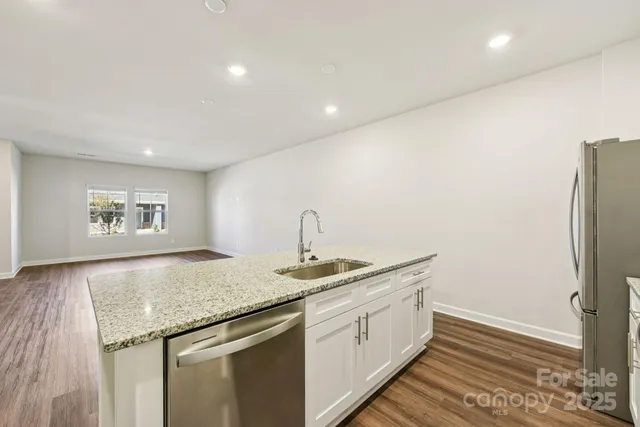 a kitchen with a sink stove and refrigerator