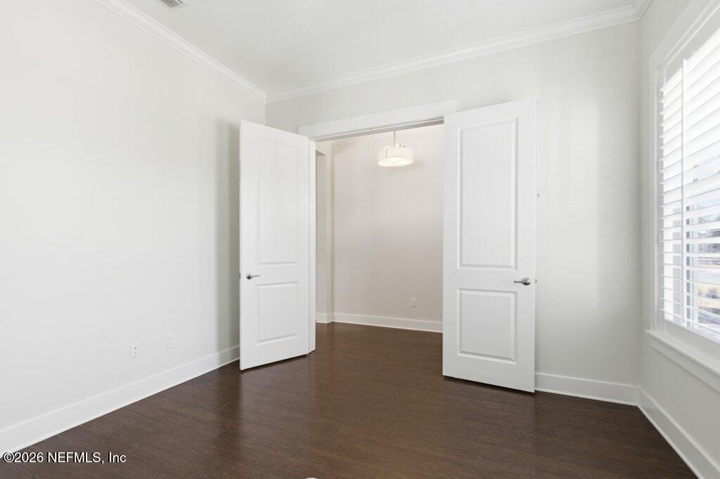 569 Timber Bridge Lane Atlantic Beach, FL 32233 - Photo 11 of 81 an empty room with wooden floor and windows