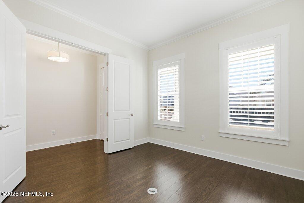 569 Timber Bridge Lane Atlantic Beach, FL 32233 - Photo 12 of 81 a view of an empty room with wooden floor and a window