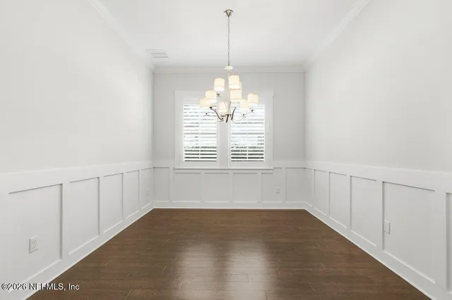 a view of a chandelier and wooden floor