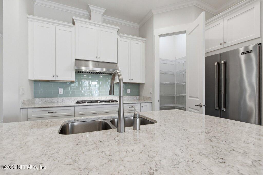 569 Timber Bridge Lane Atlantic Beach, FL 32233 - Photo 22 of 81 a kitchen with stainless steel appliances granite countertop a stove a refrigerator and a sink