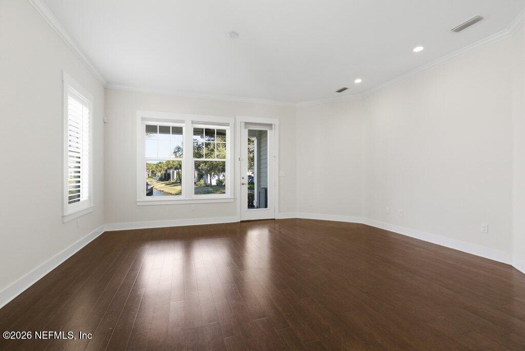 569 Timber Bridge Lane Atlantic Beach, FL 32233 - Photo 27 of 81 an empty room with wooden floor and windows