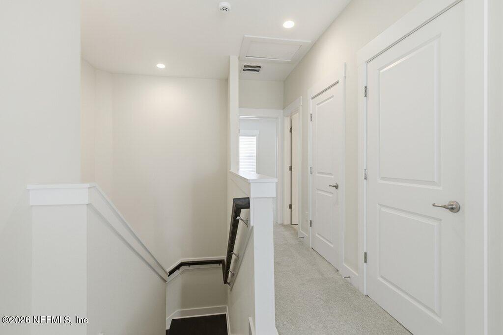 569 Timber Bridge Lane Atlantic Beach, FL 32233 - Photo 52 of 81 a view of a hallway with wooden floor and staircase