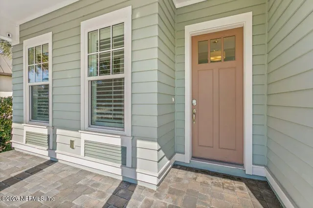 a view of a room with wooden floor and windows