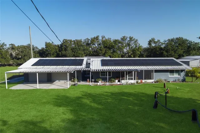 a view of a house with a yard and sitting area