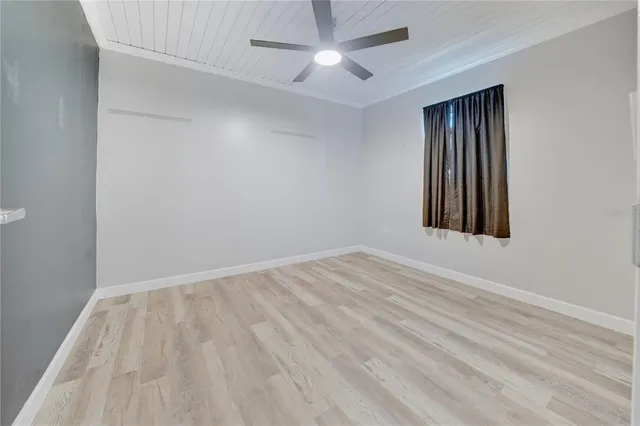 a bedroom with a large bed and a ceiling fan