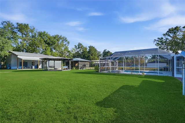 a view of a patio with a table and chairs under an umbrella