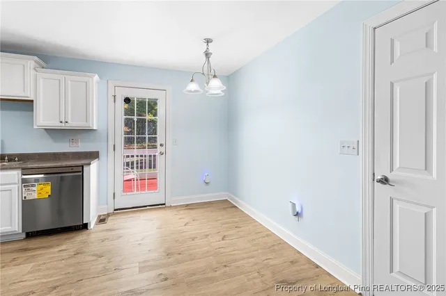 an empty room with a fireplace and wooden floor
