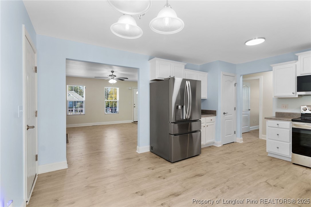 64 Humvee Court Broadway, NC 27505 - Photo 13 of 38 a kitchen with a refrigerator a stove top oven and cabinets
