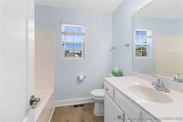 a bathroom with a sink toilet and vanity