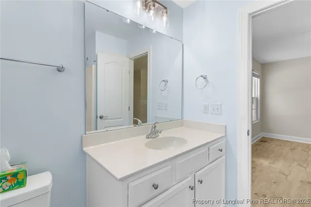 a bathroom with a sink vanity and a mirror