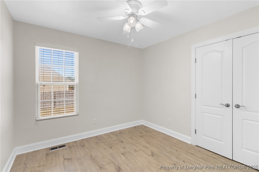 64 Humvee Court Broadway, NC 27505 - Photo 24 of 38 wooden floor in an empty room with a window