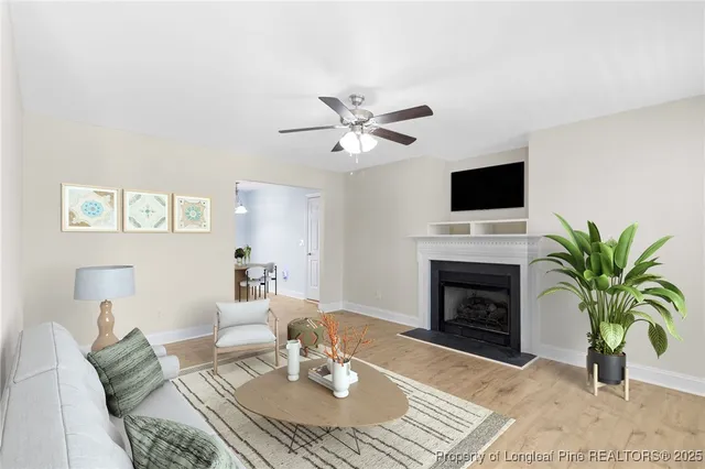a living room with furniture a fireplace and a flat screen tv