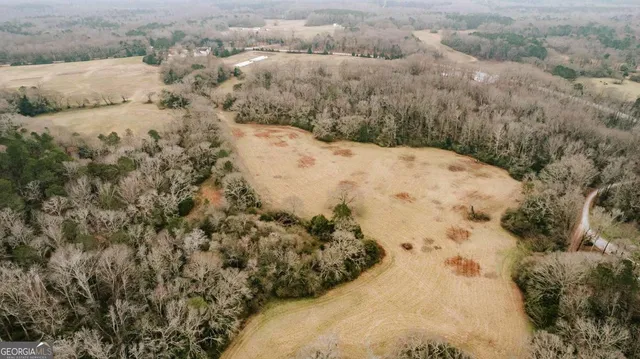 an aerial view of a house with a yard