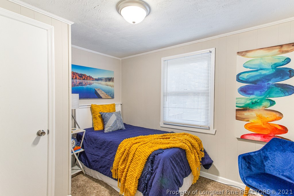 227 H T Kelly Road Cameron, NC 28326 - Photo 17 of 29 a bedroom with two beds and painting on the wall