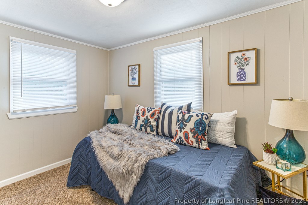 227 H T Kelly Road Cameron, NC 28326 - Photo 20 of 29 a bedroom with a bed and wooden floor
