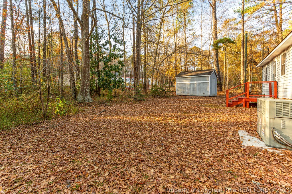 227 H T Kelly Road Cameron, NC 28326 - Photo 28 of 29 a backyard of a house with large trees
