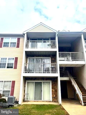 a front view of a residential apartment building with a yard