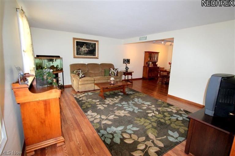 4231 Baird Road Stow, OH 44224 - Photo 5 of 23 Large living room with newer laminate floors flows into formal dining area.
