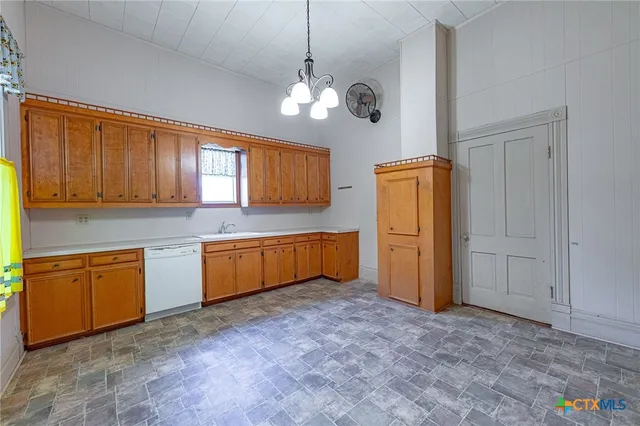 a kitchen with sink cabinets and window