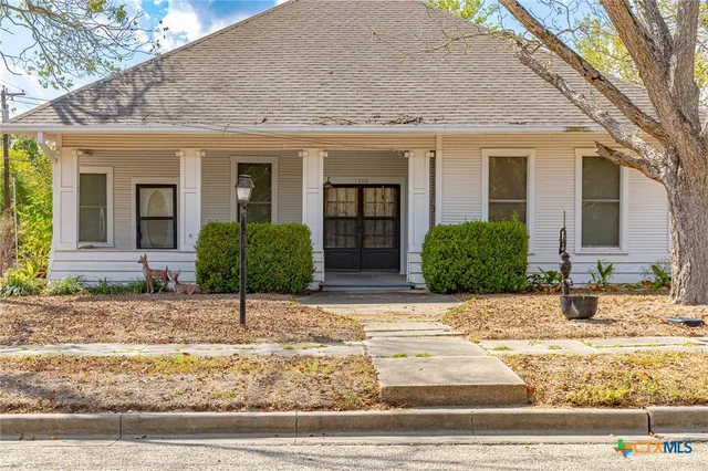 a front view of a house with a yard and a garage