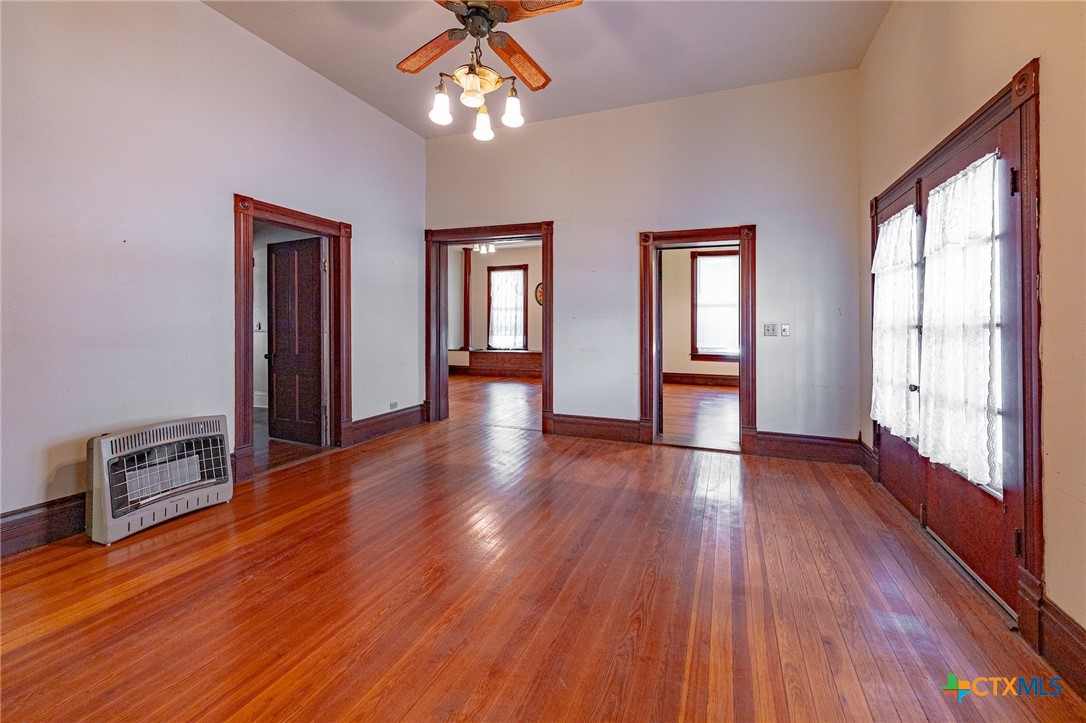 1306 Ave G Shiner, TX 77984 - Photo 5 of 23 a view of a livingroom with hardwood floor and a ceiling fan