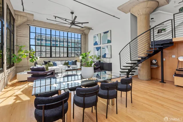 a living room with furniture a rug and a window