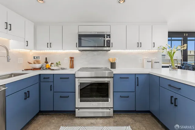 a kitchen with cabinets appliances and a sink