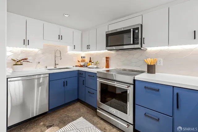 a kitchen with stainless steel appliances granite countertop a sink dishwasher stove and microwave with wooden cabinets