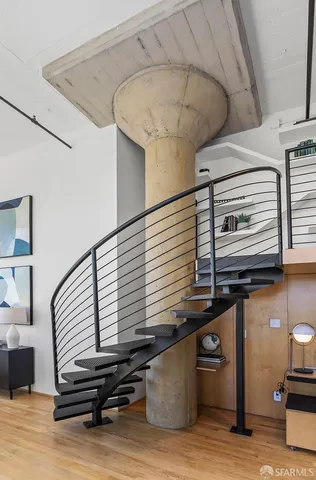 a room with pool table and stairs