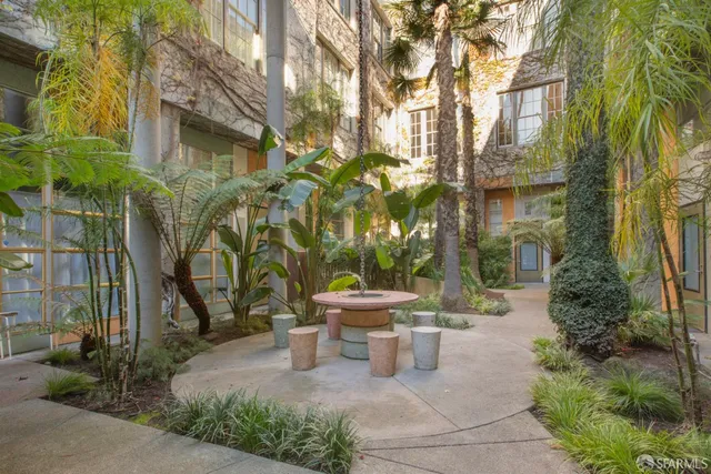 a view of a patio with table and chairs and potted plants