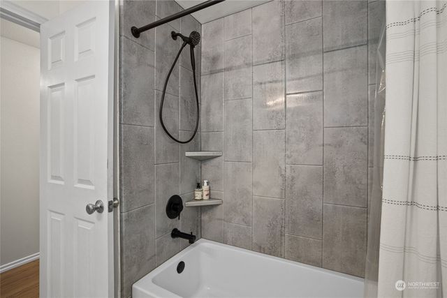 a bathroom with a shower and a bathtub