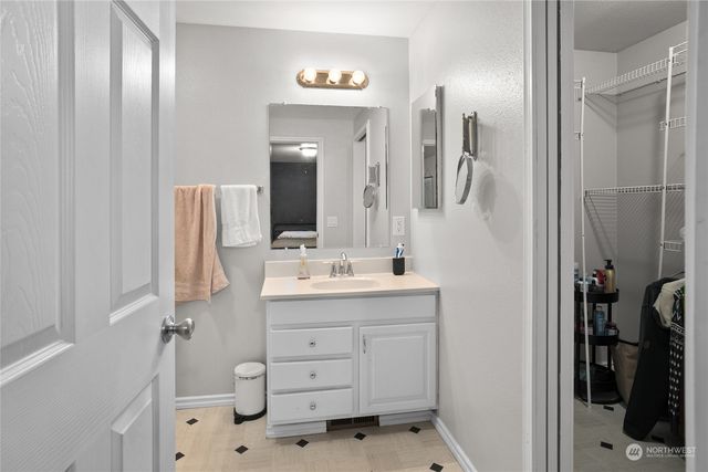 a bathroom with a double vanity sink a mirror and a shower