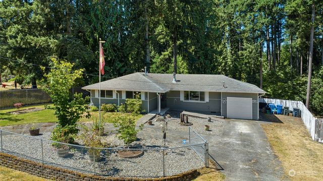 a view of a house with backyard and sitting area