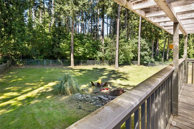 a view of a swimming pool with a patio and a yard