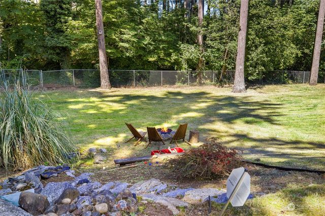 a view of a house with a yard patio and fire pit
