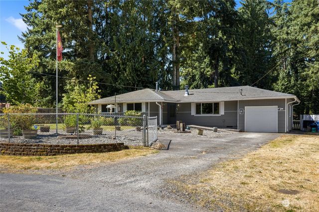 a backyard of a house with barbeque oven table and chairs