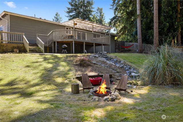 a backyard of a house with table and chairs