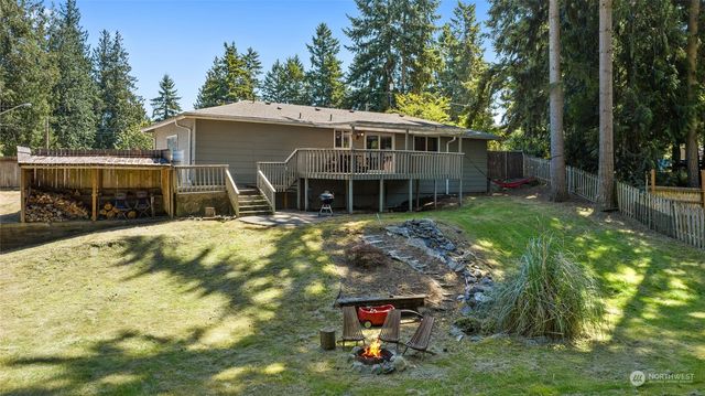 an aerial view of a house with a yard and large trees