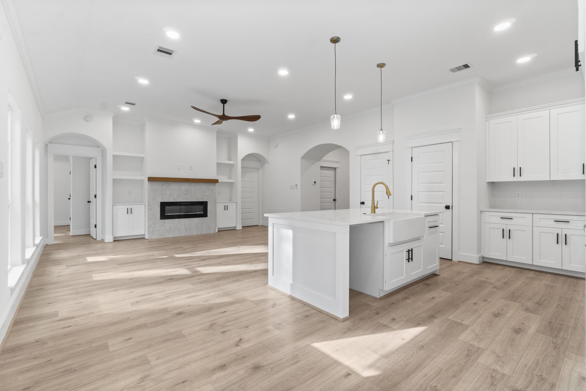 241 Clear Springs Trinity, TX 75862 - Photo 14 of 46 a large white kitchen with a sink a fireplace and cabinets