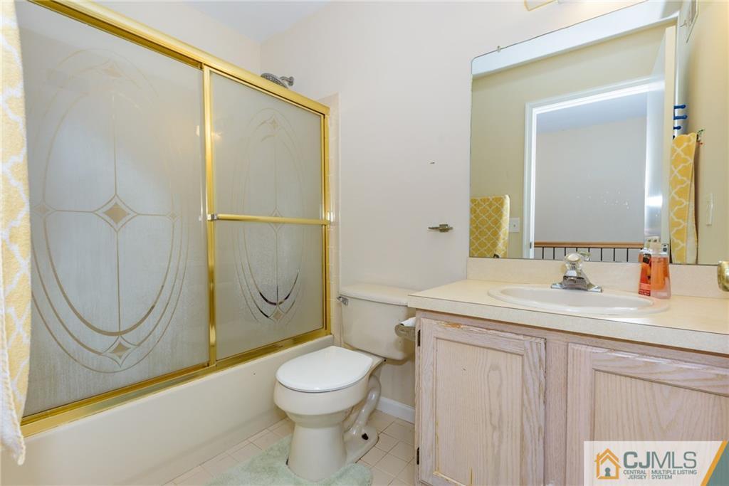 6 Yorkshire Village Road Lawrence Township, NJ 08648 - Photo 19 of 30 a bathroom with a granite countertop sink a toilet and a mirror
